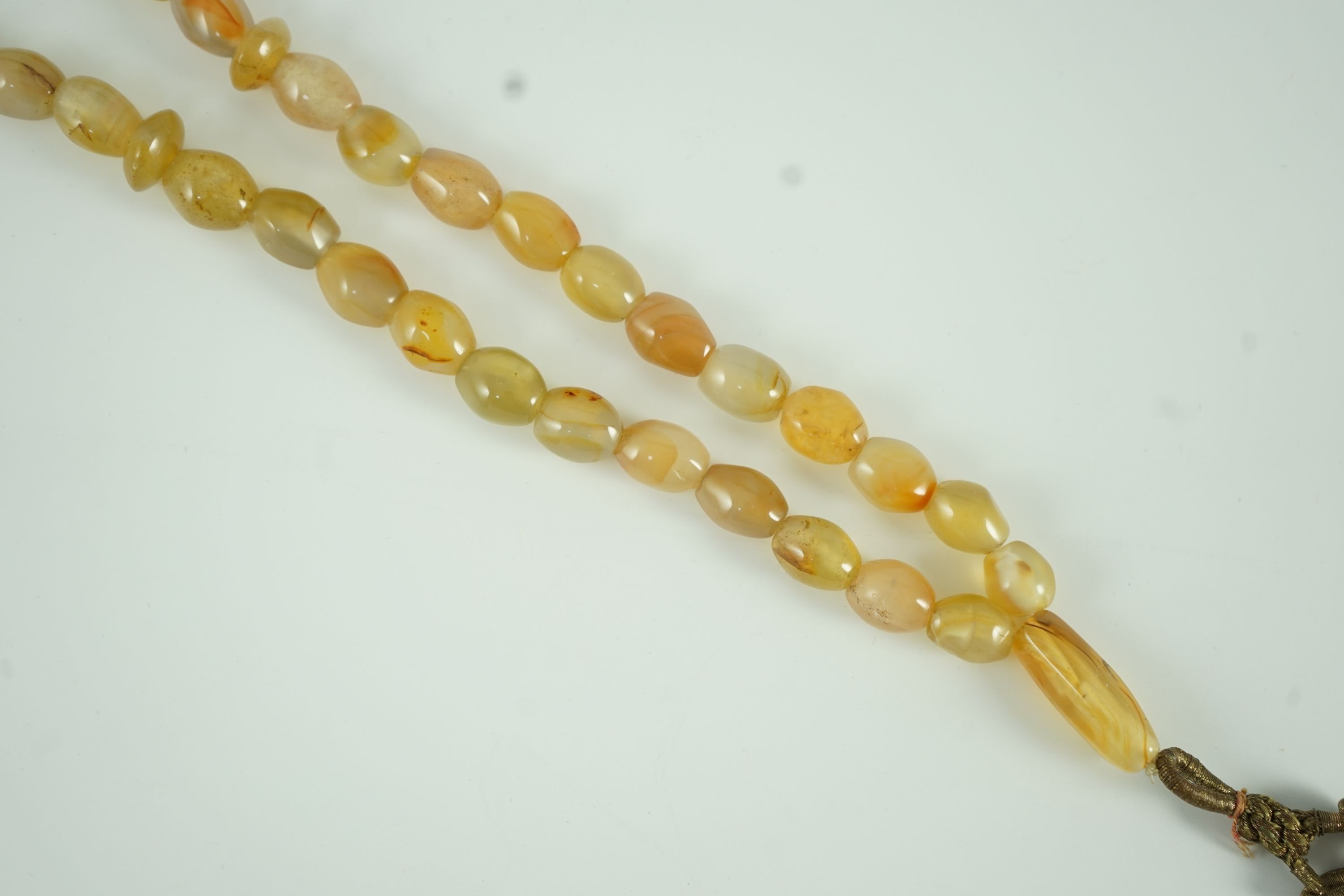 A Sino-Tibetan row of agate prayer beads, 19th century Total drop including tassel 36 cm